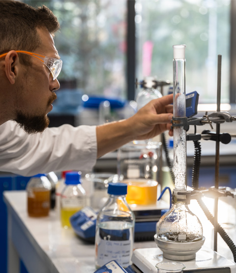 Laboratory sustainability solutions - image shows chemist at Kelpi using the Asynt oil-free heating block platform, DrySyn